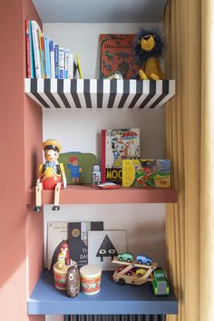 two shelves with books and toys on them