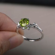 This is a gorgeous handmade creation, a combination of beauty, simplicity & Elegance. The 7*7mm round cut peridot is crafted in solid sterling silver and with rhodium plated. 14K white gold/rose gold/yellow gold available as well,pls contact me if you need. All item is sent in a beautiful gift box You can realize more lovely stuff clicking the link https://www.etsy.com/shop/knightjewelry?refshopsection_shophome_leftnav Please leave the correct address and you phone number for delivering succ Peridot Birthstone Ring For Promise Occasion, Peridot Birthstone Ring For Promise, Green Dainty Jewelry For Promise, Dainty Peridot Birthstone Ring For Gift, Dainty Peridot Birthstone Ring As Gift, Dainty Peridot Promise Ring, Dainty Green Promise Birthstone Ring, Green Dainty Promise Birthstone Ring, Green Peridot Birthstone Ring, Dainty Style