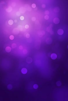 purple blurry background with lots of small circles in the middle and one light on top