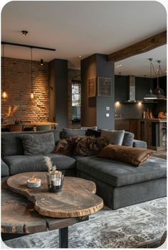 a living room filled with furniture next to a brick wall