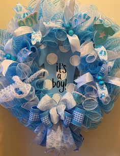 a blue and white wreath with it's a boy written on it