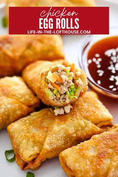 egg rolls on a plate with dipping sauce