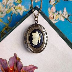 Butterfly cameo on a vintage brass, antiqued, or shiny silver-plated oval locket, perfect for remembering your loved ones.  Modeled on 28 inches of chain. Choose your desired color.         I can change the chain to any length, just leave a note at checkout. Great for pictures of your loved ones.  Simply print, cut out, and attach a photo with glue.  We do not offer printer services at this time.  Fits a 17mm by 24mm oval photo.  Each purchase includes an oval stencil that will help you cut out Antique Nickel-free Locket Necklace Collectible, Antique Nickel-free Collectible Locket Necklace, Vintage Oval Brass Necklace, Oval Metal Locket Necklace, Bronze Oval Necklace Gift, Bronze Oval Necklace For Gift, Cameo Locket Necklace As Gift, Cameo Oval Pendant Locket Necklace Gift, Vintage Charm Oval Locket Necklace