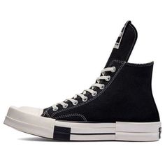 Looking for a high-top sneaker with a punk couture aesthetic? Check out the Converse Rick Owens DRKSHDW x Turbodrk Chuck Taylor All Star 1970s High in black. This sneaker is made from waxed textile with contrast white stitching and a standard All Star patch on the medial ankle. It also features an elongated tongue with a TURBODRK-branded woven tag. The high-top rides on an off-white rubber midsole, making it super comfortable to wear all day long. Plus, the squared off toe gives this sneaker a unique look that you'll love. (SNKR/Unisex/High Top/Crossover) High-top Sneakers With Contrast Sole For Streetwear, High-top Custom Sneakers With Contrast Sole For Streetwear, Streetwear High-top Sneakers With Abzorb Midsole, High-top Sneakers With Abzorb Midsole For Streetwear, Urban High-top Sneakers For Streetwear, Custom High-top Sneakers With Rubber Toe Cap For Streetwear, Converse High-top Sneakers With Rubber Sole, Converse High-top Sneakers With White Sole, Urban High-top Sneakers With Studded Outsoles