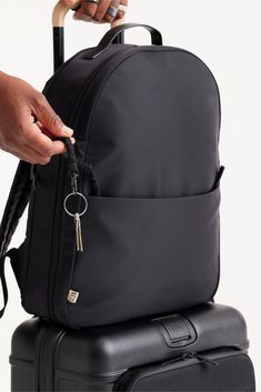 We went back to basics with an on-the-go lifestyle in mind when we designed the Commuter Backpack. It’s not just the sleek and stylish simplicity of a vegan leather handle and woven label details. This bag serves as a pre-work checklist for even the busiest days: interior organization for your computer, a front zipper pocket and elastic key leash to keep track of all the little things, plus a hidden water bottle pocket on the side (our personal reminder for you to stay hydrated!). It’s a travele Luxury Black Backpack For Commuting, Versatile Everyday Backpack With Luggage Sleeve, Functional Backpack With Leather Handles For Commuting, Functional Commuting Backpack With Leather Handles, Functional Backpack With Leather Handles For Everyday, Functional Everyday Backpack With Leather Handles, Black Leather Backpack With Detachable Strap For Commuting, Versatile Everyday Backpack With Anti-theft Pocket, Functional Backpack With Leather Handles For On-the-go