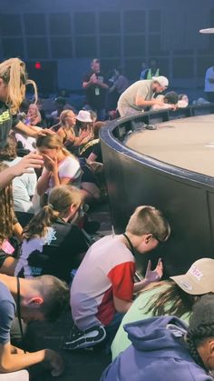 a group of people standing around a wrestling ring