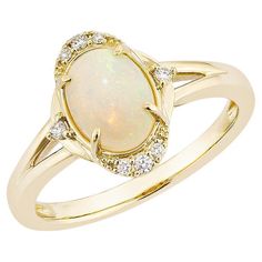 Sunita Nahata presents a stunning Ethiopian opal cabochon ring, adorned with white diamonds. This gemstone, renowned for its historical significance, is believed to bring good luck, protection, and divine hope. Its metaphysical benefits include promoting vibrant energy and attracting luck, success, and prosperity. The colorful gems make it an ideal cocktail and statement ring. Ethiopian Opal Fancy Ring in 14Karat Yellow Gold with White Diamond. Ethiopian Opal: 0.80 carat, 8X6mm size, oval shape. Fancy Rings, Cabochon Ring, Naha, Ethiopian Opal, Cocktail Rings, White Diamond, Diamond White, Statement Rings, Opal