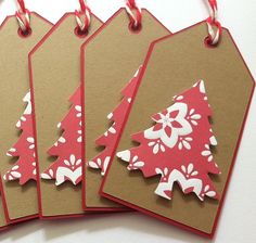 four tags with red and white christmas trees on them