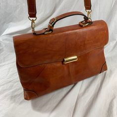 Measurements are 14"2  bottom wide, 9" high, 4" deep with a 48" shoulder strap with a 24" drop.  On the interior there are two main compartments, lined in fabric, back zipper pocket and a front top closure. Bag is made of strong leather with light stitching, silver tone hardware, top handle and the shoulder strap is detachable.   There are a few scuffs and some marks with no tears and bag is as pictured. Nice leather bag and is perfect for work, school, travel, daily use and looks great. 100% genuine leather.  ----------------------------------------------------I SHIP WORLDWIDE------------------------------------------------- I want to stress that item is vintage which means it's not new. All my customers are very important to me and I believe communication is very important. I do not sell Brown Flap Saddle Bag With Adjustable Strap, Classic Leather-lined Crossbody Saddle Bag, Classic Leather Lined Crossbody Saddle Bag, Everyday Leather-lined Flap Shoulder Bag, Everyday Flap Shoulder Bag With Leather Lining, Classic Leather-lined Flap Shoulder Bag, Leather Flap Shoulder Bag, Classic Leather Lined Shoulder Saddle Bag, Classic Shoulder Bag With Leather Lining