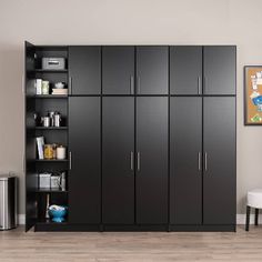 a room with black cabinets and white chairs