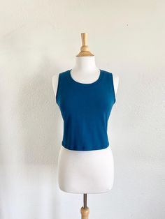 Womens basic cropped cotton knit tank top.  This is a simple semi fitted cropped length tank top that can be worn alone or layered. Made of soft stretchy cotton Lycra fabric. Machine washable.  Length from shoulder to hem is about 17.5" on size Small and increases 1/2" each size up.    See swatch chart in the last photos for available colors.  Garments are Made To Order Please allow 7-10 days for your item to be sewn Below are my standard size measurements, which are simply a guideline, if you would like to include your personal measurements in the notes to seller box during checkout, I will be sure to make you the best fit ~ if you have any questions feel free to ask :)  BASIC SIZING   XSmall 0-2 Bust 33-34, Waist 25-26, Hip 35-36  SMALL 4-6 Bust 35-36, Waist 27-28, Hip 37-38  MEDIUM 8-10 Athleisure Scoop Neck Crop Top For Everyday, Everyday Athleisure Crop Top With Scoop Neck, Workout Seamless Cotton Crop Top, Cotton Seamless Crop Top For Workout, Medium Support Cropped Yoga Crop Top, Medium Support Cropped Top For Yoga, Casual Seamless Crop Top For Everyday, Cotton Crop Top For Yoga, Cotton Yoga Crop Top