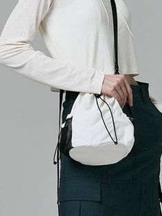 This is a casual and comfortable mini bucket bag that is made out of high quality polyester and nylon 100% fabric. With design detail of detachable cross strap and logo print on the back, it gives a trendy and casual mood.- Matte texture of nylon fabric- 3M elastic string and logo print on the back - Detachable cross strap White Nylon Crossbody Shoulder Bag, Casual White Shoulder Bag For On-the-go, White Bucket Shoulder Bag With Mobile Phone Pocket, White Nylon Bags With Zipper Closure, White Nylon Bag With Zipper Closure, White Bucket Shoulder Bag With Phone Pocket, White Shoulder Bucket Bag With Mobile Phone Pocket, White Shoulder Bucket Bag With Phone Bag, White Crossbody Bucket Bag For On-the-go