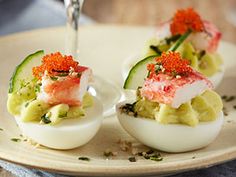 deviled eggs stuffed with crab and cucumber are served on a white plate