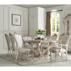 a dining room table with chairs and a china cabinet