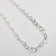 This sweet heart bracelet comes in sterling silver and 14k yellow gold so it makes for a lasting keepsake. Featuring a chain made of dainty little heart shaped links that measure approximately 3.4mm wide. Perfect as a gift or treat yourself, the bracelet is adjustable in size as you can easily make it a smaller fit by attaching the clasp to any link on the chain. Secures with an easy-to-use lobster clasp and the longest fit is 7.5 inches. This chain is also offered in our permanent jewelry line. Sterling Silver Double Heart Bracelet, Valentine's Day Jewelry With Adjustable Link Chain, Adjustable Delicate Sterling Silver Bracelet As A Gift, Valentine's Day Link Jewelry With Adjustable Chain, Minimalist Heart Bracelet With Adjustable Chain For Anniversary, Sterling Silver Double Heart Bracelet Gift, Dainty Sterling Silver Bracelet With Adjustable Chain For Gift, Sterling Silver Heart Bracelet With Adjustable Chain For Anniversary, Adjustable Delicate Sterling Silver Heart Bracelet