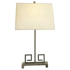 a table lamp with a white shade on it's base and an iron frame