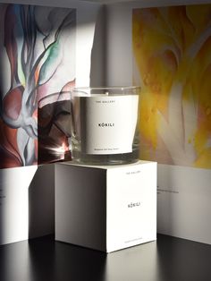 a candle sitting on top of a white box