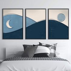 three paintings on the wall above a bed