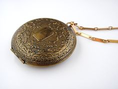 "Welcome to my Instagram account @Jewelrin Vintage/ Antique Old Metal Brass Unmarked Floral Locket Necklace Pendant. I believe this item to be made of brass but I could be mistaken. The locket shows overall wear including scratches and discoloration; the clasp still works well. The chain is made of goldtone metal. Measurements/size: The chain measures 27\" (68 cm). The locket measures 2\" (5 cm ) in diameter. Marks or signatures: Unsigned Condition - Very good vintage condition. Take a look at m Ocean Shores, Old Metal, Dior Logo, Largest Butterfly, Butterfly Brooch, Rhinestone Bracelet, Monogram Logo, Locket Necklace, Round Earrings