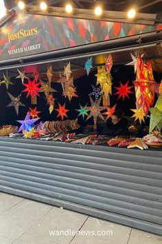 a store front with colorful paper stars on display