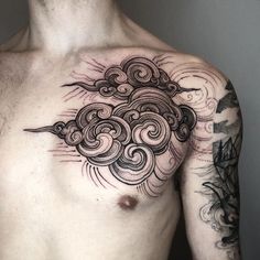 a man's chest with clouds and waves tattoo on his left side, while the other half is in black ink