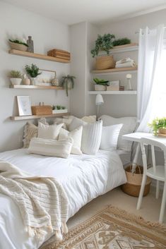 a white bed sitting in a bedroom next to a desk and shelves filled with plants