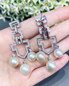 We are presenting you a HUGE pair of ONE OF A KIND, CHANDELIER, Genuine, CLASSIC WHITE South Sea Pearls, extremely FINE AA+, LUSTROUS and Rare! Accenting the 6 pearls are 144 pieces of E/VS Natural diamonds, weighting a total of 1.64 carats. Set in fabulously designed 18K solid white gold earrings! TIMELESSLY CLASSIC! WITH GORGEOUS Art Deco DESIGN. ONLY ONE ITEM AVAILABLE!! NO DUPLICATES!! WHAT YOU SEE IN THE PICTURES IS WHAT YOU WILL GET SOLIDLY HANDCRAFTED EARRINGS! SUGGESTED RETAIL VALUE: $10 White Gold Diamond Bridal Earrings With Pearl Drop, White Diamond Pearl Earrings With Elegant Design, Diamond White Aaa Quality Jewelry For Wedding, Elegant White Diamond Pearl Earrings, Elegant White Diamond Dangle Earrings, Luxury Pearl Dangle Earrings For Formal Occasions, Diamond Dangle Bridal Earrings With Pearl Drop, White Gold Chandelier Earrings With Elegant Design, Elegant Diamond Chandelier Earrings