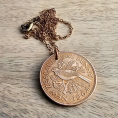 "A 1964 New Zealand one penny vintage coin necklace, featuring a large copper pendant made from a genuine coin, demonetized and out of circulation.  The coin hangs on a durable brass cable chain with lobster claw clasp.  The chain length can be selected at checkout.  The sample length is 24\".  See all photos for specific visual details.   DIAMETER OF COIN: 1 1/4\" (32 mm)  Your 1964 New Zealand bird one penny coin necklace is ideal as a birthday or anniversary gift for someone celebrating a milestone in that year or for someone who loves New Zealand.  It will be gift boxed, ready for giving or storage.   Enjoy! DRWR23" Vintage Bronze Coin Necklace, Vintage Coin Necklaces For Anniversary, Vintage Bronze Round Coin Necklace, Vintage Coin Necklaces As Gift, Vintage Nickel-free Necklaces For Commemoration, Vintage Nickel Free Necklaces For Commemoration, Vintage Coin Necklaces For Gift, Vintage Coin Necklace For Commemoration, Vintage Coin Necklace With Medallion Shape As Gift