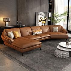 a living room filled with lots of brown furniture and decor on top of a gray rug