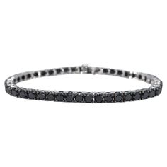 The item in question is a luxurious bracelet adorned with 44 black diamonds, boasting a total weight of 16.50 carats. The diamonds are cut in the brilliant style, which enhances their sparkle and light reflection. The color of the diamonds is a rich black, with an opaque appearance that has been enhanced to achieve a deeper shine. The quality of the cut is regarded as very nice, suggesting that the diamonds have been skillfully shaped to maximize their brilliance. The bracelet is crafted from 14 karat gold, with a hallmark confirming its authenticity. It has a total weight of 17.5 grams, indicating a substantial but comfortable piece. The bracelet measures 18.5 cm in length, making it suitable for most wrist sizes. This item is in new condition, with no visible signs of wear, and the quali Classic Round Black Diamond Bracelet, Classic Tennis Bracelet With Black Diamonds, Classic White Gold Diamond Bracelet With Black Diamonds, Classic White Gold Bracelets With Black Diamonds, Classic Tennis Bracelet With Black Diamonds For Formal Occasions, Formal Tennis Bracelet With Black Diamonds, Luxury Black Diamond Bracelet With Round Shape, Classic Black Diamond Bracelet, Classic Black Diamond Tennis Bracelet