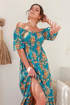 A fun floral maxi dress with a gorgeous teal color to make the look pop. This dress has short sleeves with an elastic neckline, allowing you to style the dress on or off the shoulders. There are two elastic lines below the chest for shaping. The rest of the dress is loose, flowy, and ready for a lunch date with friends. Model is 5'10" and wearing her true size Small. Small: Bust 14", Length 52" 100% Rayon Fitted Off Shoulder Short Sleeve Beach Dress, Blue Off Shoulder Maxi Dress For Spring, Fitted Off Shoulder Dress With Short Sleeves For Vacation, Short Sleeve Off Shoulder Dress For Brunch, Casual Off Shoulder Maxi Dress For Brunch, Casual Maxi Length Off Shoulder Dress For Brunch, Turquoise Maxi Dress For Spring, Turquoise Maxi Dress For Spring And Summer, Summer Blue Maxi Dress With Elastic Neckline