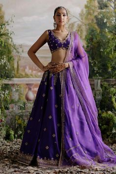 Orchid purple attached cancan lehenga with floral dori, aari embroidery. Paired with embroidered padded blouse and embroidered dupatta.
Components: 3
Pattern: Embroidered
Type Of Work: Floral
Neckline: V neck
Sleeve Type: Sleeveless
Fabric: Chanderi, Organza, Lining: Shantoon
Color: Purple
Other Details: 
Back tie-up detailing
Scallop border
Approx. product weight: 7-8 kgs
Note: The outfit worn by the model on left is not for sale
Occasion: Wedding - Aza Fashions Purple Indian Outfit, Modern Lehenga Designs, Modern Lehenga, Eye Embroidery, Purple Lehenga, Blouse Lehenga, Lehenga Pattern, Raw Silk Lehenga, Lehenga Designs Simple