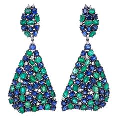 18K Black Rhodium Gold. Emeralds: 17.42ct total weight. Blue Sapphires: 22.30ct total weight. Diamonds: 1.04ct total weight. All diamonds are G-H/SI stones. Emerald Drop Earrings, Diamond Chandelier Earrings, Diamond Chandelier, Peacock Colors, Emerald Blue, Blue Sapphire Diamond, Expensive Jewelry, Emerald Earrings, Women Diamond