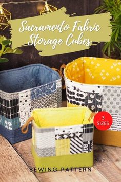 three fabric storage baskets sitting on top of a wooden table