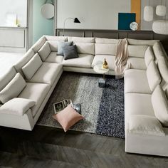 a large white couch sitting on top of a wooden floor