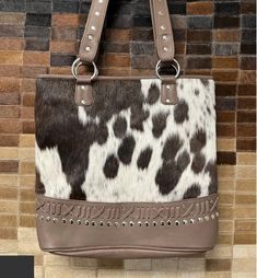 "Brown Twist cowhide purse Beautiful hand crafted cowhide designed in our unique pattern. Backed with our embossed leather design. Each cowhide purse is hand made with the finest leather and hair on hide. Each cowhide color will vary. If you would like to choose the bag you receive please leave a comment at checkout. measures: 12x13x1\"	is_active	21075419	Apparel & Accessories > Handbags =>  Wallets & Cases > Handbags	https://www.etsy.com/listing/1113310220/brown-twist-cowhide-p Cow Print Leather Bag For Daily Use, Leather Cow Print Bag For Everyday Use, Western Style Leather Rectangular Shoulder Bag, Cowhide Ottoman, Cowhide Purse, Cowhide Bag, Leather Coasters, Leather Items, Leather Design