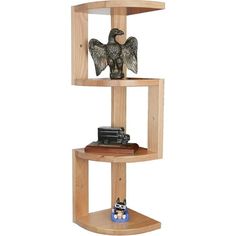 a wooden shelf with an eagle figurine sitting on it's top and two bookshelves below