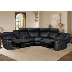 a black leather sectional sofa with recliners on top of it in a living room