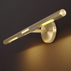 a wall light that is on the side of a wall with a white tube attached to it