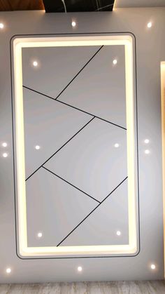 a mirror that is on the wall with lights around it and a light up frame