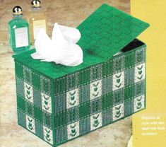 a green box with tissue and other items in it