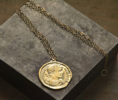 Gold coin necklace, coin necklace, gold coin pendant, antique necklace, delicate gold necklace, antique coin necklace, gold pendant necklace Delicate gold pendant necklace with an antique coin pendant, great for everyday wear, unique and beautiful. The necklace is made of 14k gold filled The pendant is an original antique Greek gold coin, which I duplicated and later casted and plated with 14k gold. The gold coin necklace is also available in sterling silver. Dimensions: The pendant's diameter i Bronze Brass Coin Necklace With Round Pendant, Antique Gold Coin Pendant Medallion Necklace, Antique Gold Coin Necklace In Brass, Antique Gold Medallion Necklace With Coin Pendant For Gift, Antique Gold Brass Medallion Necklace With Coin Pendant, Yellow Gold Medallion Chain Necklace With Coin Pendant, Yellow Gold Brass Chain Necklace With Coin Pendant, Vintage Brass Coin Necklace, Tarnish Resistant, Vintage Brass Coin Necklace Tarnish Resistant