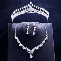 A delicate three-piece bridal jewelry set for the romantic bride! Adorned with intricately faceted cubic zirconia that capture the light from every angle with a perfectly translucent appeal, the pieces are rhodium plated for a flawless finish which enhances the intricate detailing and conveys a modern take on old elegance. Necklace: 17" long (approx. 43.2cm) with a 2" extension chain (approx. 5cm) for comfortable sizing (if you would like it longer, please include a note with the preferred lengt Elegant Silver Bridal Sets With Rhinestones, Wedding Jewelry Sets In White Gold With Diamond Accents, Elegant Crystal Bridal Sets With Rhinestones, Elegant Bridal Sets With Rhinestones And Crystal, Silver Bridal Sets With Diamond Accents, Dazzling Diamond-accented Jewelry Sets For Wedding, Dazzling Diamond Accented Jewelry Sets For Wedding, Elegant Silver Hand Set Bridal Sets, Elegant Crystal Bridal Sets For Bride