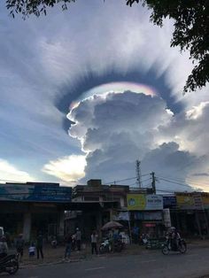 a very large cloud with a rainbow in the sky