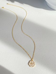 Adorn yourself with the beauty of nature with our Camellia pendant necklace! This necklace features a stunning camellia flower that represents love, admiration and gratitude. The elegant design is completed with sterling silver plated with gold cable chain, making it perfect for everyday wear or special occasions.  It's so beautiful either have it alone or layered with other necklace, have it with dress or sweater. Pendant size is 1.2cm Necklace length is 40+5.5cm As it's a handmade item please allow 2-3mm difference. Please keep them away from chemicals such as perfume, hairspray ect. Better remove before shower and swim.   The product is made by care and love 💕 Elegant Flower Charm Necklace For Mom, Delicate Rose Gold Charm Necklace With Flower, Delicate Rose Gold Flower Charm Necklace, Elegant Rose Gold Flower Charm Necklaces, Elegant Rose Gold Flower Charm Necklace, Feminine Necklace With Flower Pendant For Her, Feminine Flower Pendant Necklace As A Gift, Feminine Necklace With Flower Pendant As Gift For Her, Delicate Jewelry With Flower Charm On Round Pendant