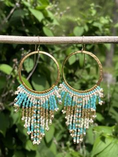 Caution! These earrings attract attention! For a fun in the sun, a concert, date night, or any occasion where you want to be the star of the show-gorgeous beaded gold hoop statement earrings featuring premium seed beads in a pearlescent cream, aqua and gold boho pattern. Handmade. Designed & created in my home studio. SIZE 3.25 inches long 1.5 inches wide MATERIALS 14k gold filled ear wires lead and nickel free hoop premium delica seed beads beading thread Summer Gold Jewelry With Dangling Beads, Summer Dangle Jewelry With Gold Beads, Gold Jewelry With Tiny Beads For Summer, Summer Gold Jewelry With Tiny Beads, Summer Festival Jewelry With Round Beads, Summer Festival Jewelry, Beaded Bohemian Hoop Earrings For Summer, Colorful Beaded Earrings For Summer, Summer Beaded Drop Earrings