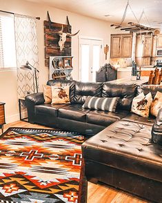 a living room filled with furniture and a rug on top of a hard wood floor