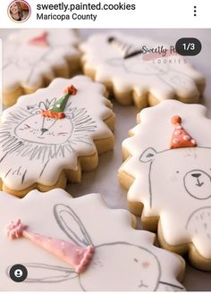 decorated cookies with drawings on them sitting on a table