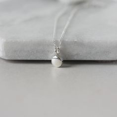 A dainty minimalist accessory that's perfect for everyday wear! This necklace features a tiny sterling silver pebble charm paired with sterling silver cable chain. The small disc is 5mm wide and about 2mm thick and it has a sleek bright polish that gives the necklace a modern feel. The simple design makes this a versatile accessory and it looks chic alone or layered with others. The necklace is fastened with a sterling silver spring ring clasp and you can choose your desired length from the drop Dainty Necklace Layered, Pebble Necklace, Dot Necklace, Minimalist Accessories, Celestial Necklace, Crescent Moon Necklace, Everyday Necklace, Disc Necklace, Layering Necklace