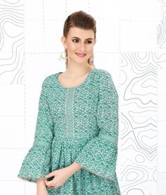 SHORT KURTA TOP - GREENISH BLUE & WHITE color . Blue & white paisley motif. Hip length with sleeves just below the elbow. Round shaped neck with side adjustable strings. Slightly flared & Mirror Embroidery all over. 100% lightweight cotton. Cool wash with mild detergent. Dry clean preferred. Product details- Only kurta (Pants/Leggings ) on display are not included . Spring Cotton Salwar Kameez With Mirror Work, Anarkali Tunic Kurta With Mirror Work, Anarkali Style Kurta With Mirror Work, Eid Tunic With Mirror Work, Spring Festive Tunic With Printed Motifs, Long Sleeve Kurta With Yoke For Eid, Eid Long Sleeve Kurta With Yoke Detail, Eid Kurta With Yoke Detail And Long Sleeves, Spring Anarkali Long Sleeve Blouse